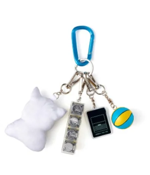 Keychain with various charms including a ball, phone, and pillow on a white background
