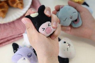 Cute plush toys resembling animals held by hands with a blurred background. Xdinary Monsters SECRET FACE Baby Plush keyring collection