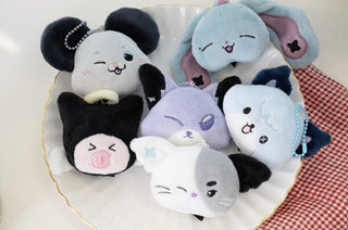 Set of cute plush toys resembling animals on a decorative plate. Xdinary Monsters SECRET FACE keyring random 1 of 12